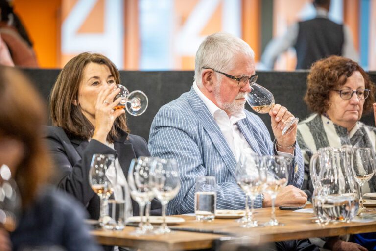 Food Show visitors tasting wine at a wine masterclass.